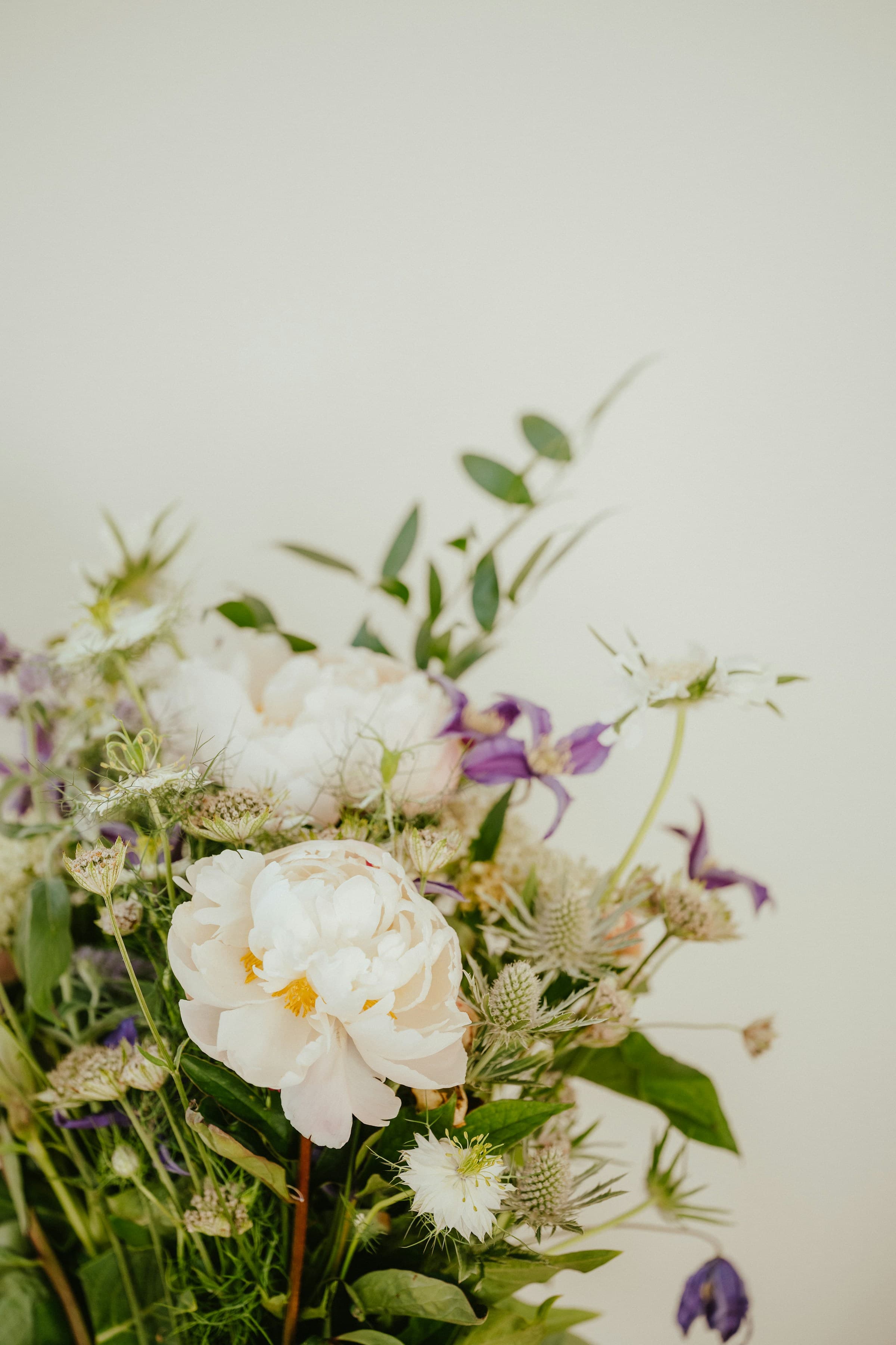 A loose mixed seasonal bouquet in soft indoor natural light